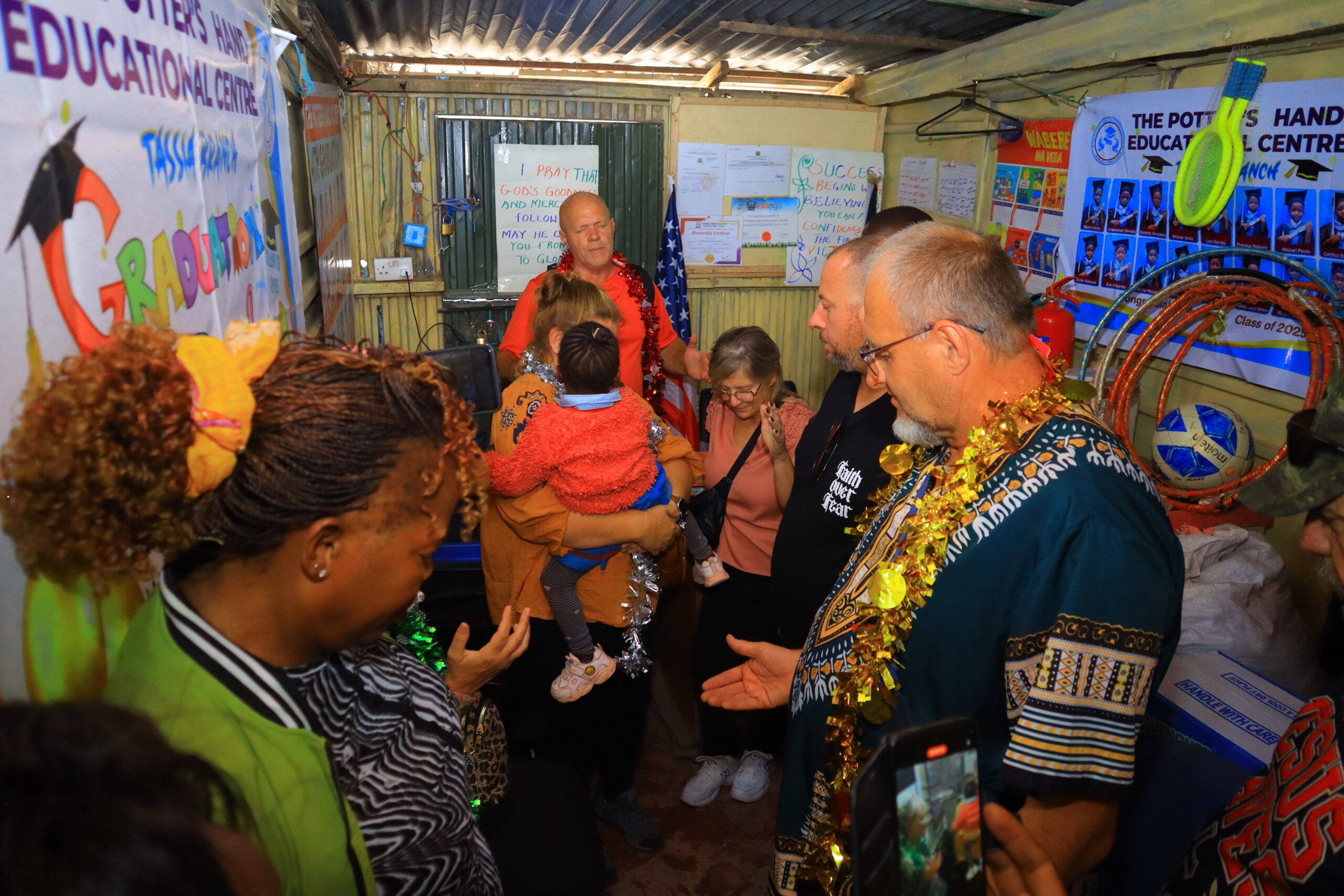 Local hosts and visiting ministry participants gathered indoors near musical equipment in Kenya