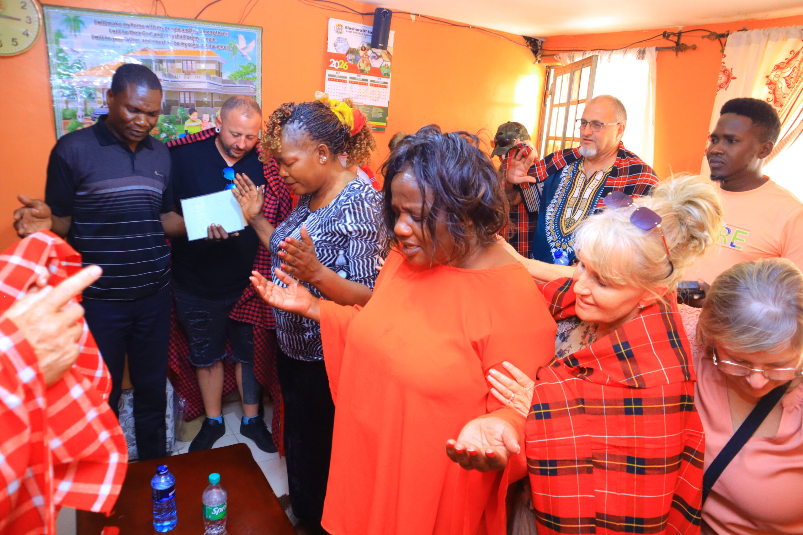 Ministry participants praying together during a community visit in Kenya
