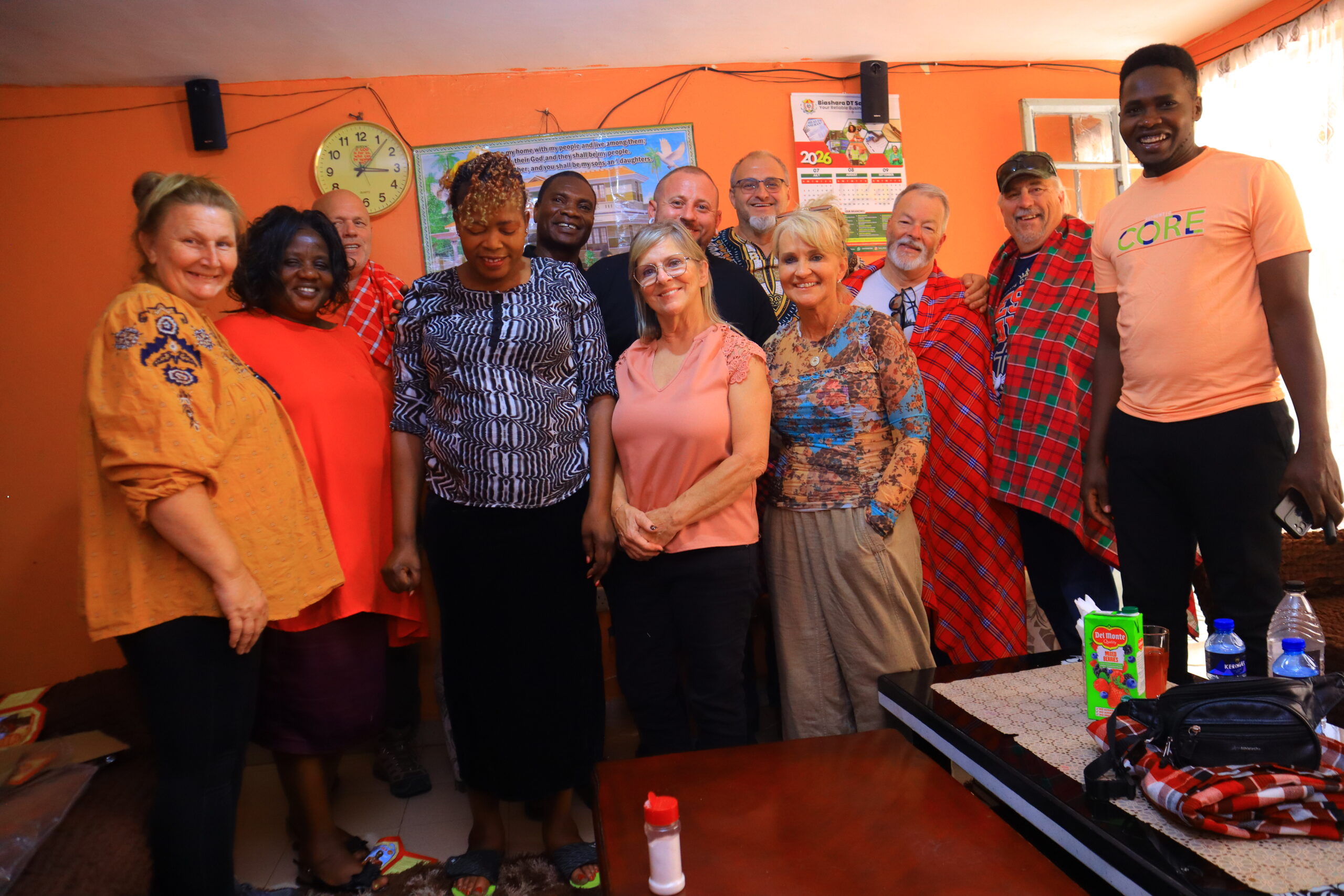 Local hosts and visiting ministry participants gathered for an indoor team photo in Kenya